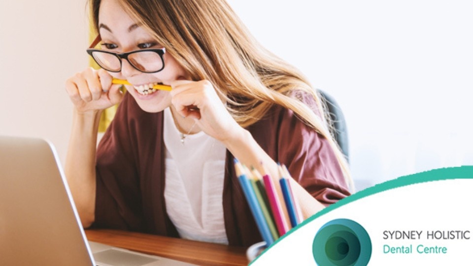 women biting pencil
